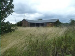 Barn set in rough grassland